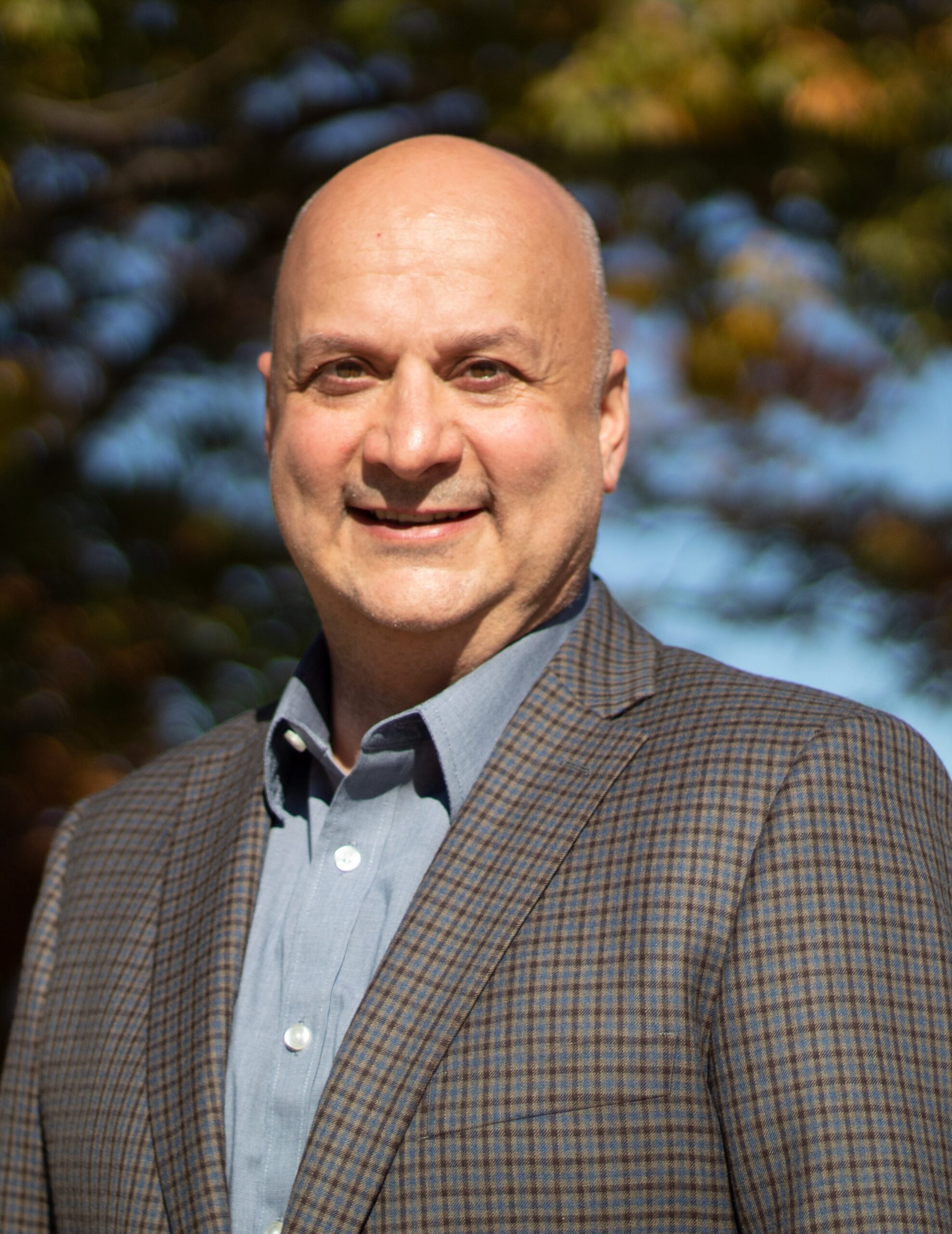 Head shot of a man in a sport coat and blue collared shirt